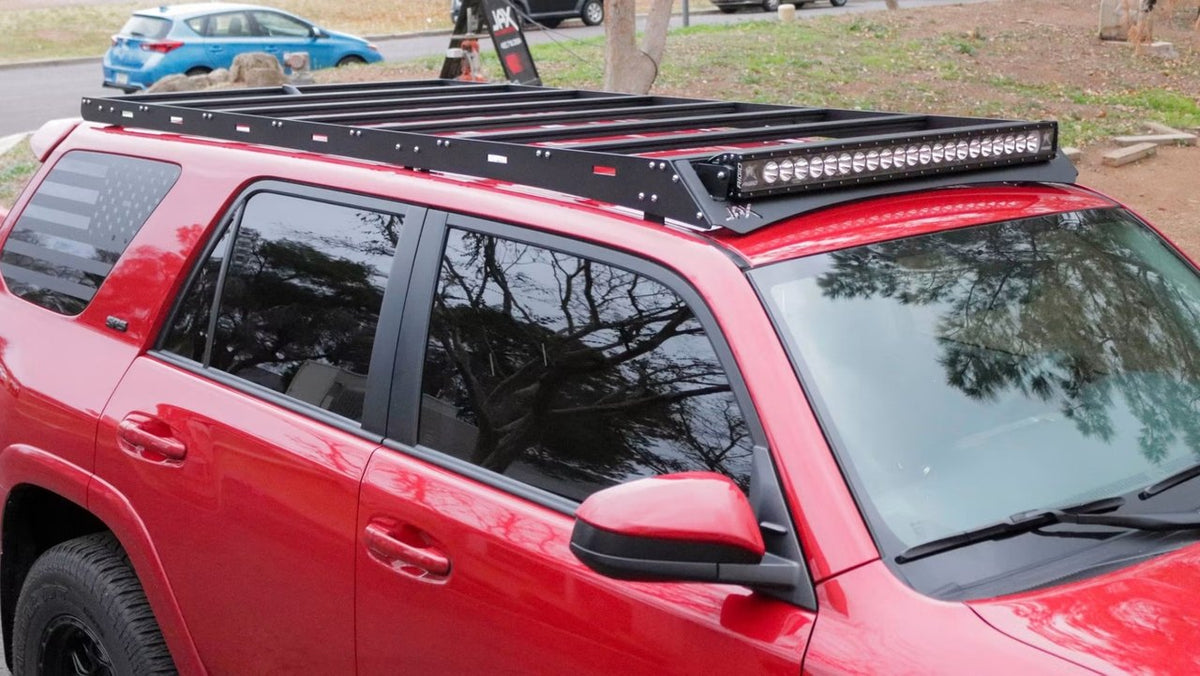 Red Toyota 4Runner with a black low-profile roof rack and integrated LED light bar installed by Jax Motorsports in Gilbert, AZ