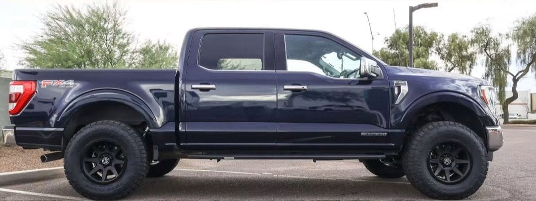 Full passenger-side profile of the lifted F-150 Lariat