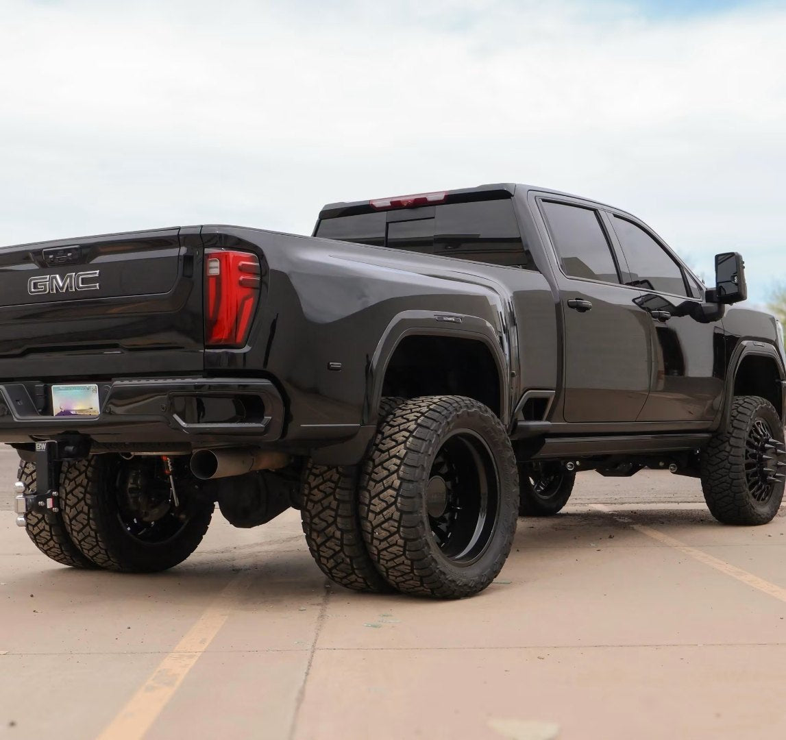Rear three-quarter view of the blacked-out GMC Sierra 3500 HD Denali dually