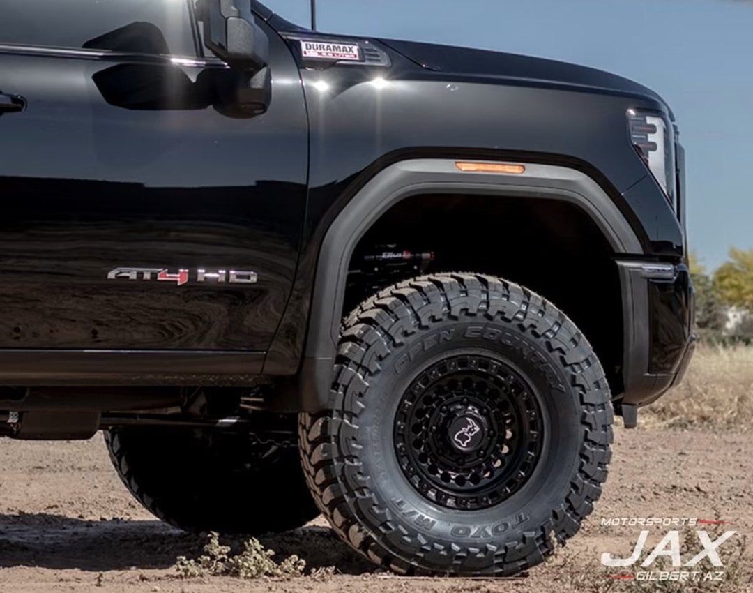 Close-up of the front wheel, fender and DURAMAX badge on the GMC AT4
