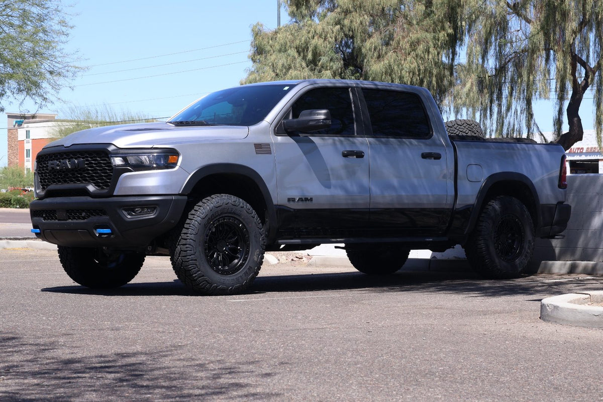 Front driver-side three-quarter view of the 2025 Ram 1500 Rebel with Arena wheels and Goodyear Duratrac RT tires