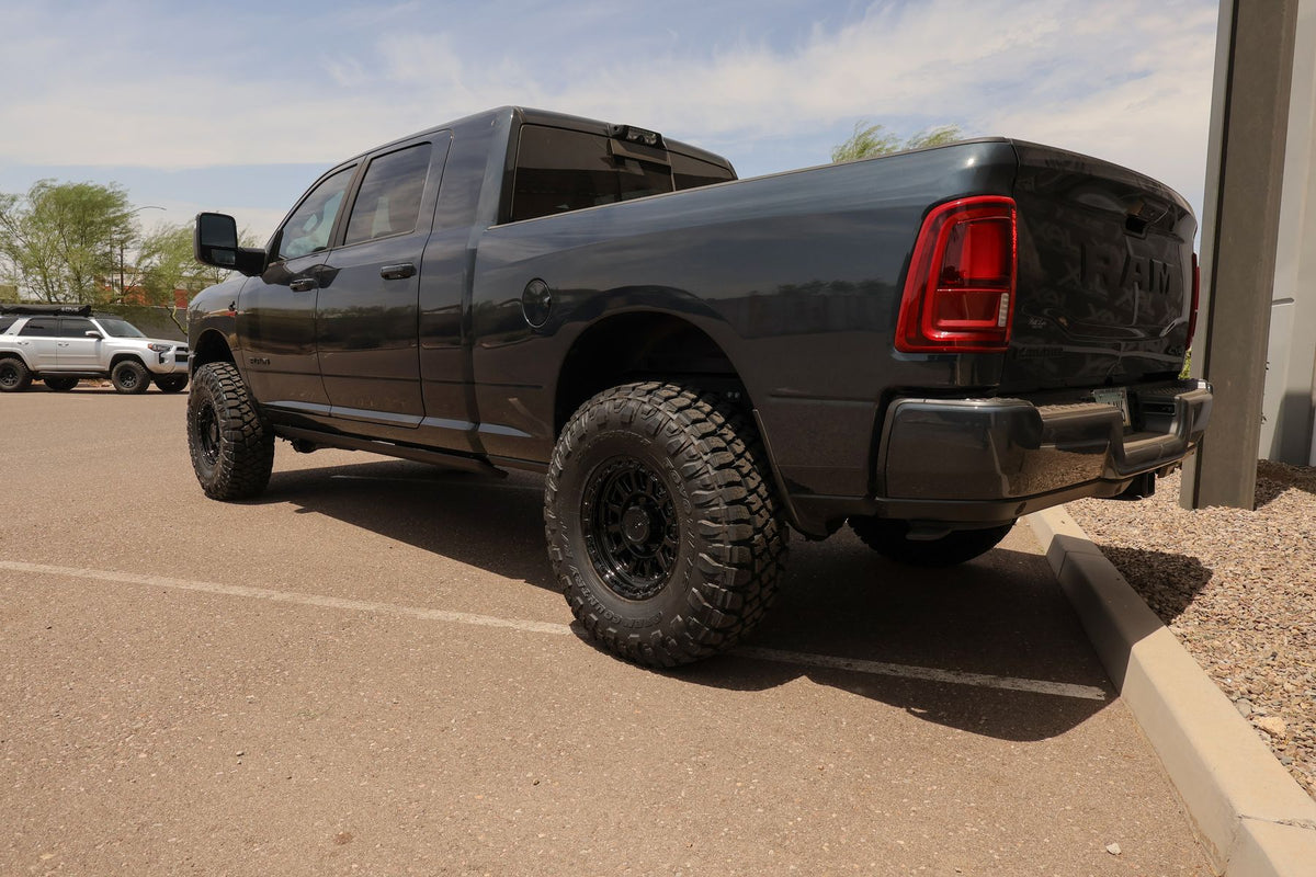 Rear three-quarter of the Ram 2500 Mega Cab Laramie on gloss black Arena Enduro wheels