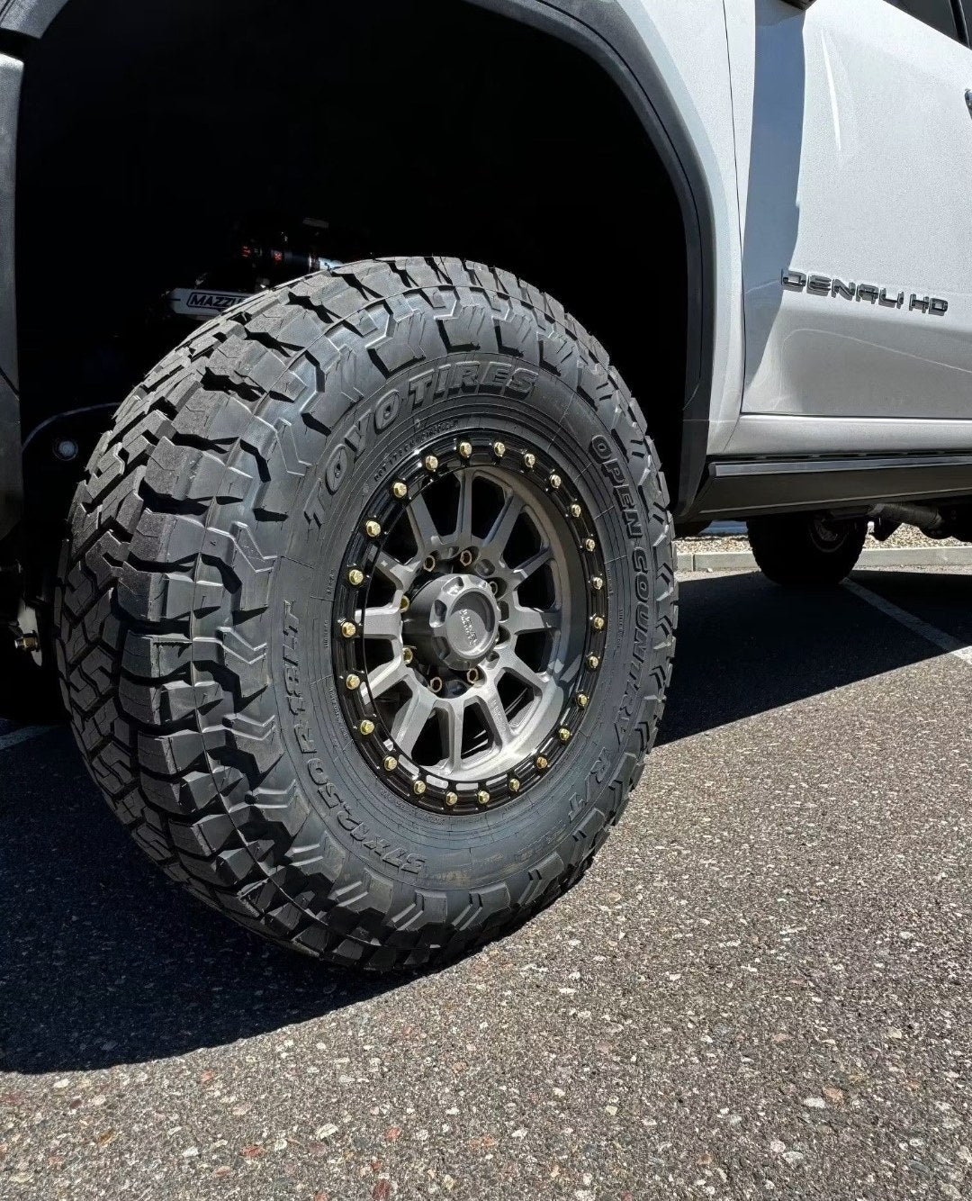 GMC Sierra Denali HD with KMC wheels and Toyo Open Country R/T 37x12.50R18LT tires installed at Jax Motorsports