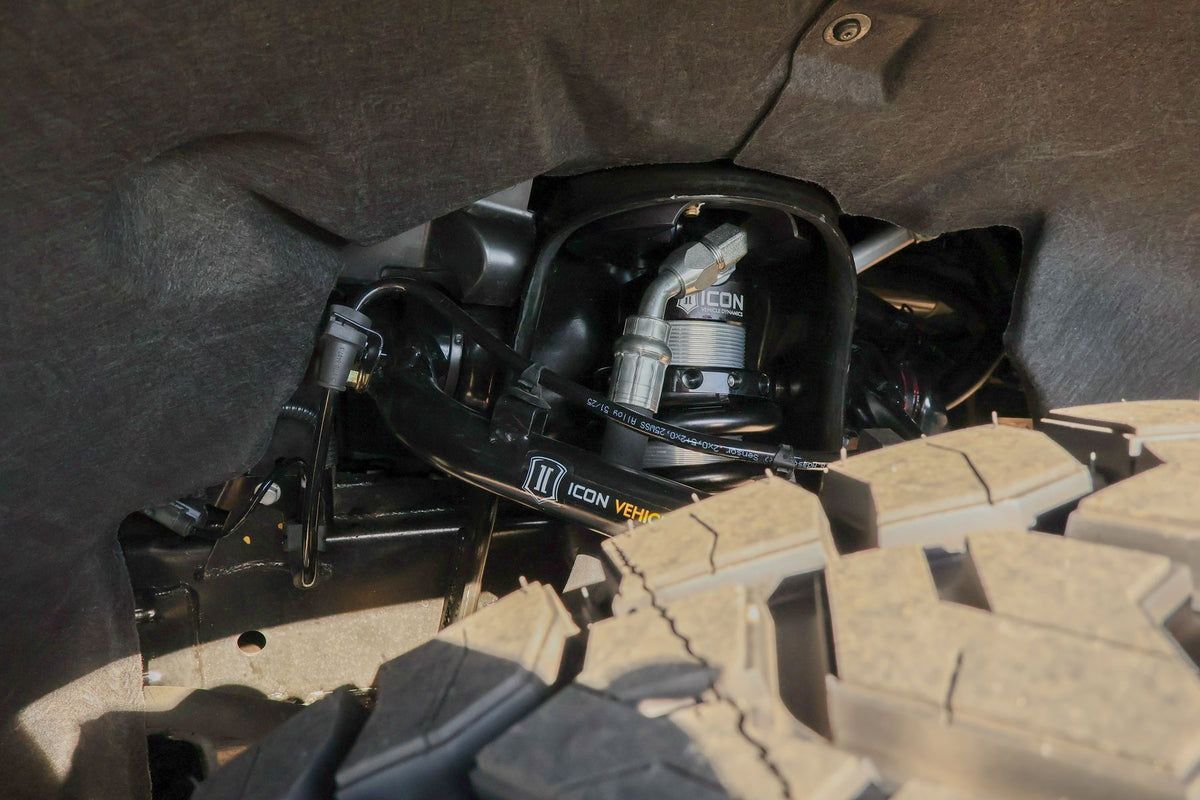 Icon Vehicle Dynamics 2.5 front coilover with reservoir and tubular upper control arm installed in the Colorado Trail Boss wheel well