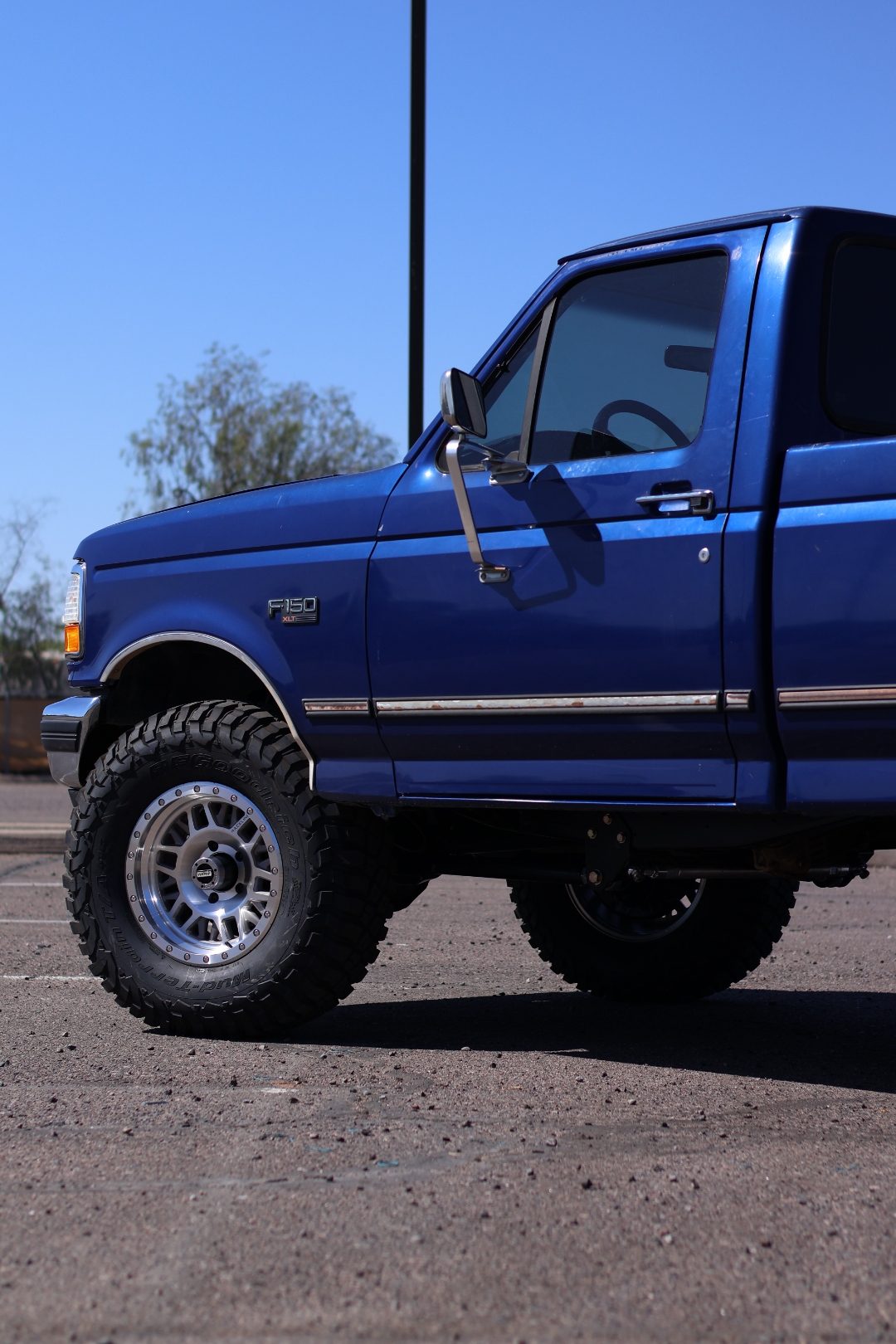 Driver-side profile of the lifted dark-blue OBS F-150