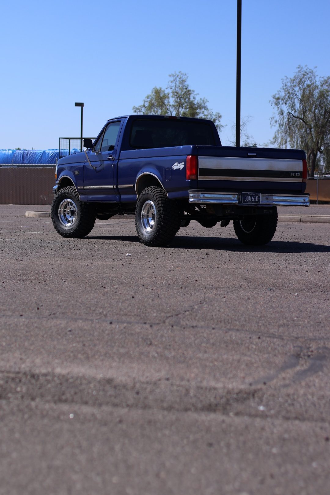 Rear three-quarter view of the lifted OBS F-150 showing the long-travel suspension